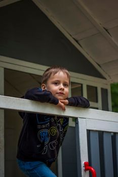 A child is playing on the playground in a children's house. Presents himself as the owner of the house. Portrait of a child. childhood, games, joy, emotions.