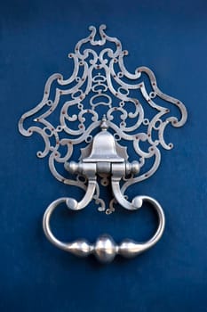 Bronze knocker on a wooden door in Bordeaux, France