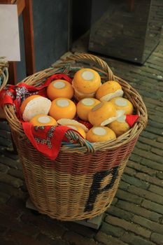 Traditional Dutch cheeses on display in a wicker basket