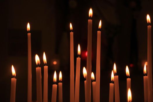 Long thin candles in a roman catholic church