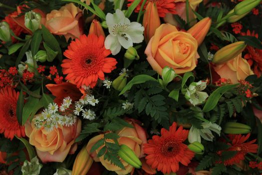 Orange and white wedding bouquet with various flowers