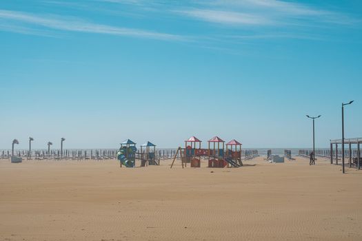 Children playground on the beach. Slide and climbing frames. General view. Italy