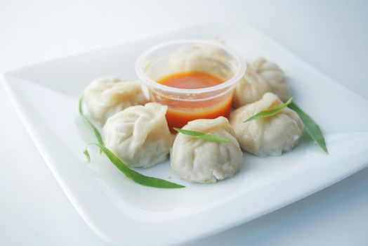 close up of chicken momo dumpling on a plate .