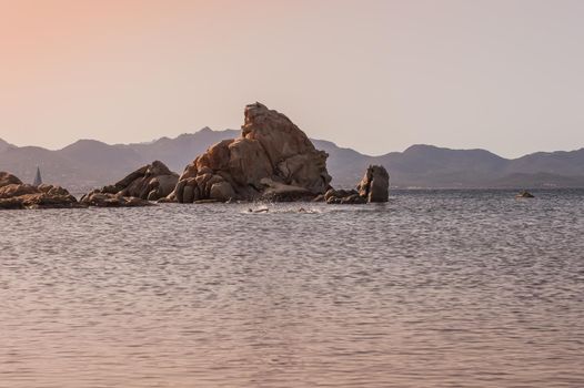 sunset sea with rocks and mountains in the background.beautiful sea.Sardinia
