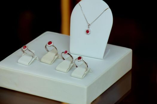 Classic Diamond engagement rings in a shop window, red ruby with diamond halo