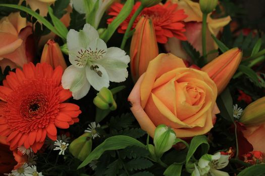 Orange and white wedding bouquet with various flowers