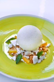 Vanilla ice cream, lemon and basil on a plate