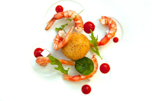 Risotto fritter, prawns and tomato sauce on a plate