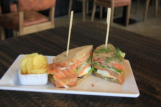 A fresh salmon sandwich: smoked salmon, lettuce, fresh dill and egg