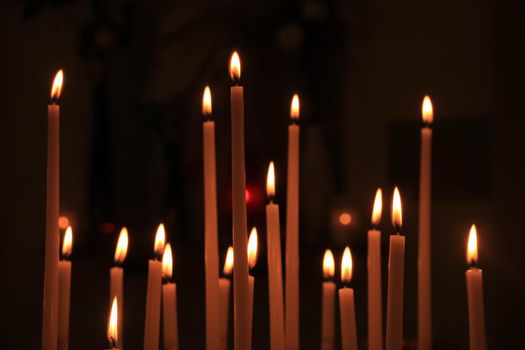 Long thin candles in a roman catholic church