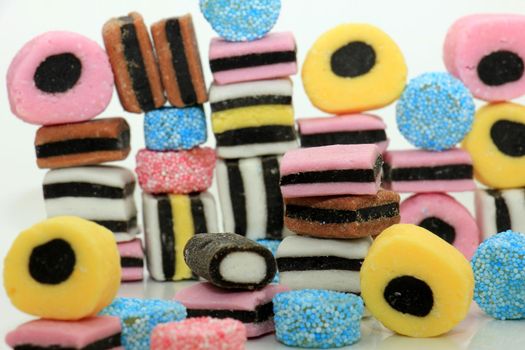 Stacked liquorice all sorts in different shapes, colors and sizes