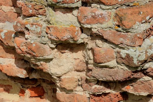 Vintage red bricks in an old brick wall