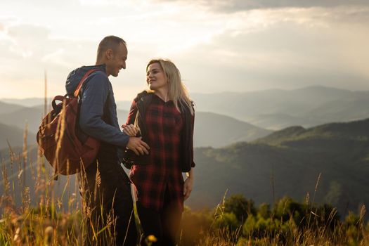 beautiful young couple enjoying nature at mountain.