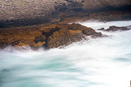 Atlantic ocean. Stormy summer day Big sea wave on rocky beach. Beaty in nature. Dramatic sea view. Long exposure