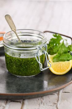 Green delicious herbal marinade of cilantro, basil, parsley, oil, traditional seasoning for salad dressing