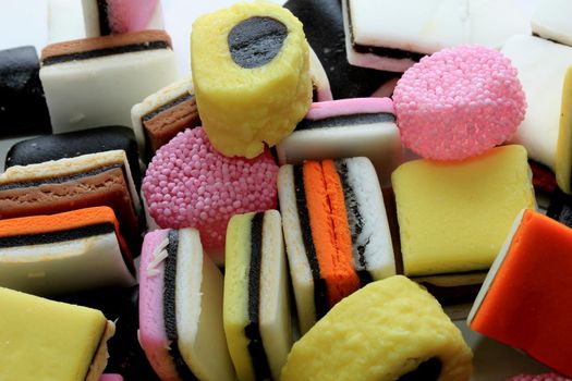 Pile of liquorice allsorts in different shapes, colors and sizes