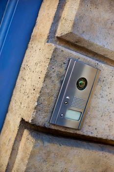 Modern intercom on the stone wall of an old French house