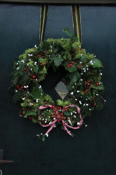 Classic christmas wreath with decorations on a door