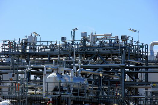 Silos and heavy metal pipes of an industrial plant, Chemical industrial industry