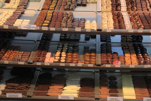 Luxurious Chocolates on display in a confectioner's shop (tags: price and product information in Dutch)