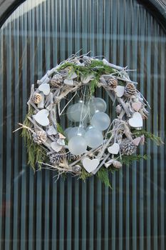 christmas wreath with decorations on a door