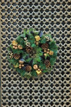 Classic christmas wreath with decorations on a door