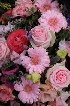 Various pink flowers in a mixed floral arrangement