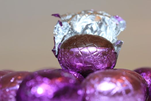 colorful wrapped chocolate easter eggs in close-up, macro