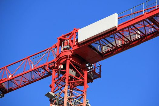 Tall construction crane at a construction site