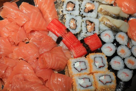 Japanese sushi and sashimi, various sorts on a serving plate