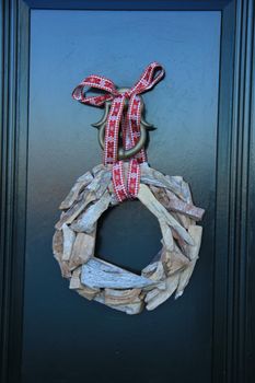 Classic christmas wreath with decorations on a door