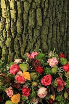 A floral sympathy wreath near a tree