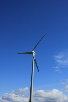 A Wind turbine generating electricity in a blue sky