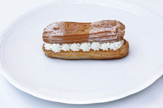 Classic appetizing dessert on a white plate in a kitchen