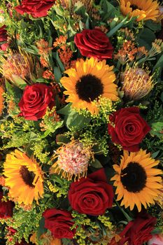 Sunflowers and big red roses in a wedding arrangement