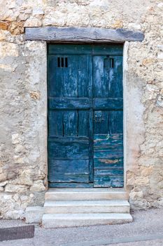 dark blue wooden exterior door in a small european village