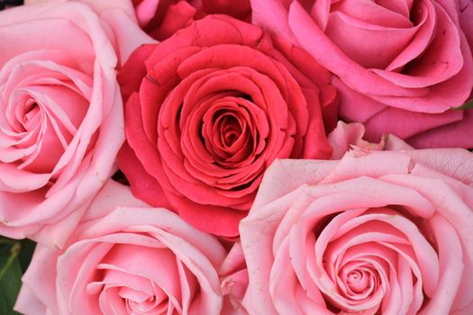 Big pink roses in a floral wedding arrangement