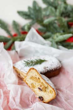 Christmas adit on a red background, a slice is cut off. Traditional Christmas holiday dessert. Stolen at Christmas