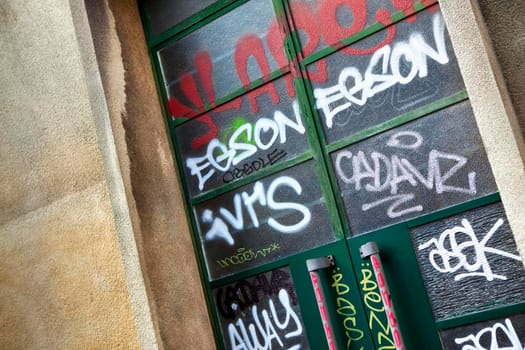 Graffiti and tags on a glass door