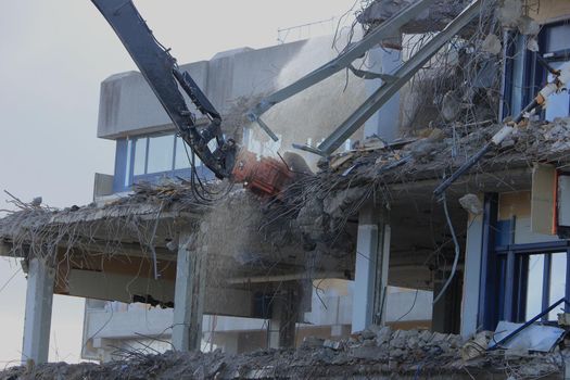 Demolishing a building with hydraulic crushers