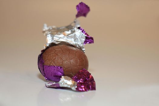 colorful wrapped chocolate easter eggs in close-up, macro