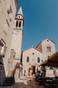 Old Town, Budva, Montenegro. Picturesque square in the well preserved medieval Old town with shops, cafes and restaurants in the Balkans. The view of Budva medieval fortress of St. Mary, Citadel, landscape of Old town Budva, Montenegro: ancient walls, beautiful Landscape