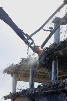 Demolishing a building with hydraulic crushers