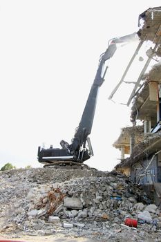 Demolishing a building with hydraulic crushers