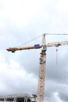 Tall construction crane at a construction site