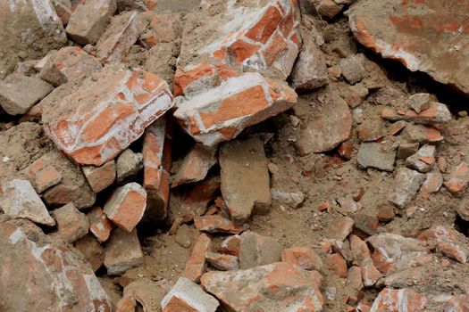 Pile of broken red bricks on construction site