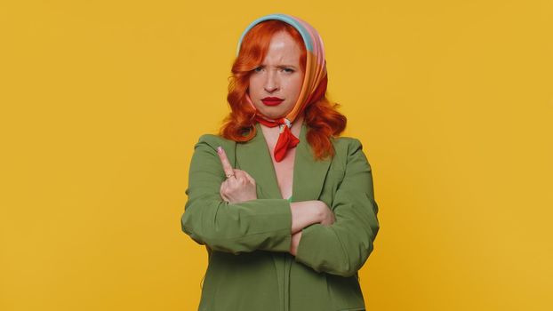 Aggressive Crazy Hooligan Redhead Young Woman Showing Around Her Middle Fingers Demonstrating Protest With Impolite Rude Gesture Of Disrespect Rejecting Communication. Ginger Girl On Yellow Background