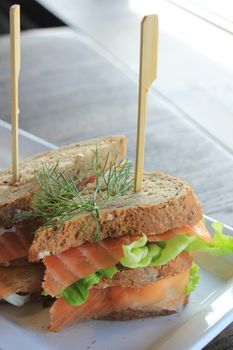 A fresh salmon sandwich: smoked salmon, lettuce, fresh dill and egg