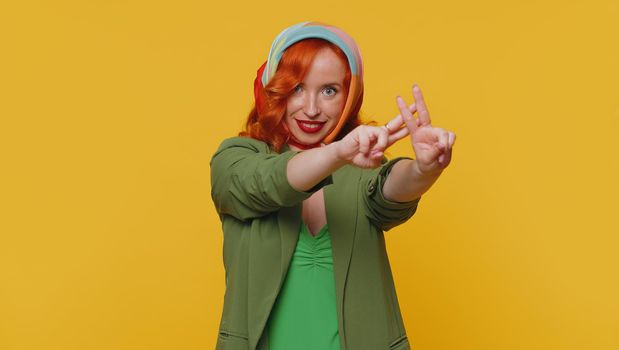 Hashtag. Cheerful redhead young woman showing hashtag symbol with hands, likes tagged message, popular viral content, sign to follow internet online trends. Ginger girl isolated on yellow background