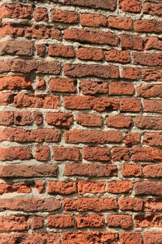 Vintage red bricks in an old brick wall